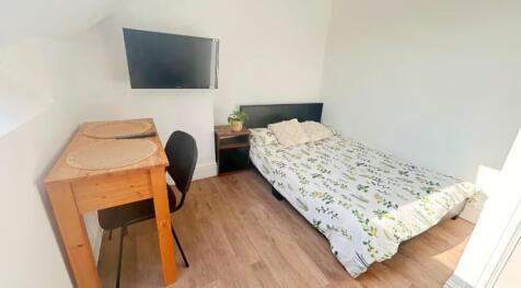 A bright and inviting double bedroom featuring ...