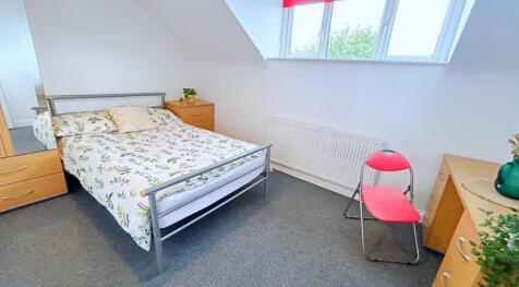 Cozy double bedroom featuring a comfortable bed...