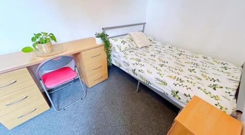 This cozy double bedroom features a comfortable...