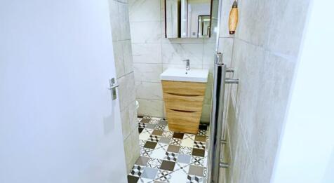 A modern bathroom featuring stylish tilework an...