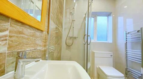 This modern bathroom features a stylish shower ...