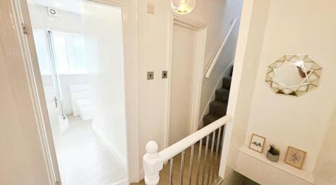 Welcoming hallway with modern decor, providing ...