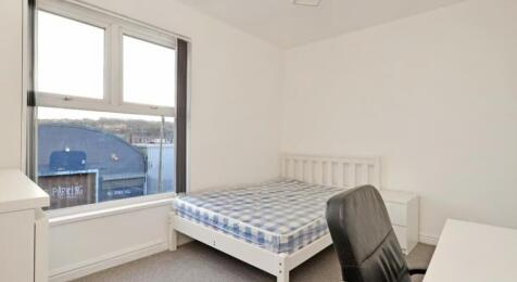 This inviting double bedroom features a comfort...