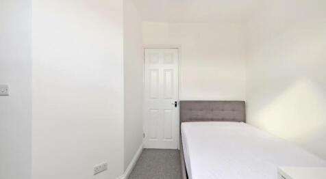 This inviting double bedroom features a neutral...