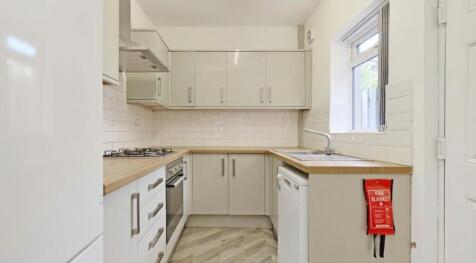 This modern kitchen features sleek cabinetry, a...