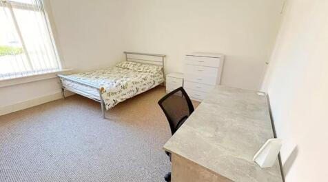 A bright and inviting double bedroom featuring ...