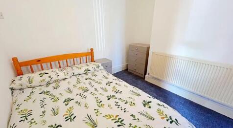 This inviting double bedroom features a cozy am...