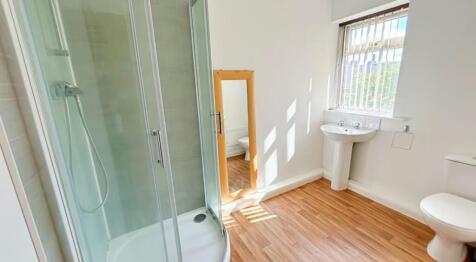 Bright and modern bathroom featuring a spacious...