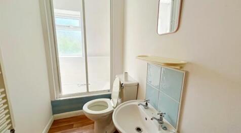 Bright and modern bathroom featuring a clean de...