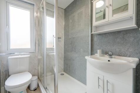 Bright, modern bathroom featuring a clean white...