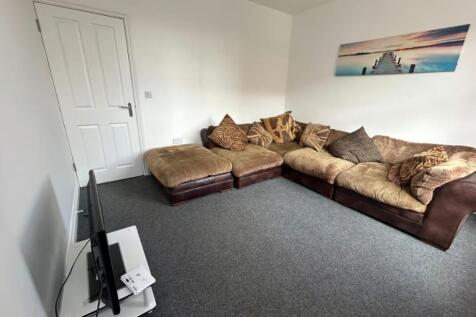A cozy living room featuring a spacious, comfor...