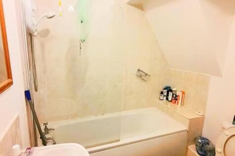 Bright and functional bathroom featuring a spac...
