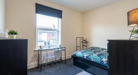 This inviting double bedroom features a cozy am...