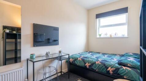 This cozy double bedroom features a stylish bed...