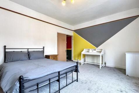 Spacious double bedroom featuring vibrant wall ...