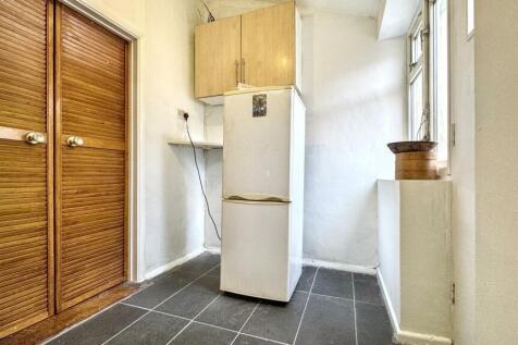 This cozy kitchen features a modern refrigerato...