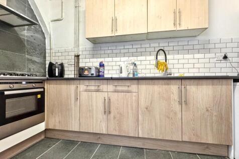 This modern kitchen features sleek cabinetry an...