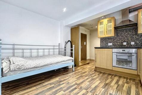 This charming double bedroom features a cozy de...