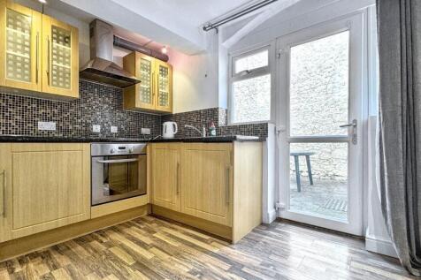 A modern kitchen featuring sleek cabinetry and ...