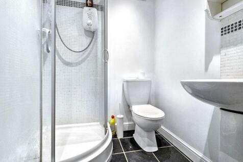 A modern bathroom featuring a sleek shower and ...