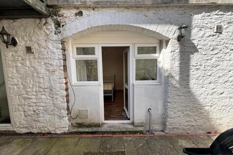 Welcoming entrance featuring large windows that...