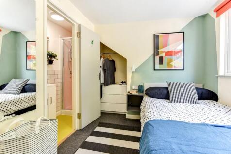 This inviting double bedroom features a cozy la...