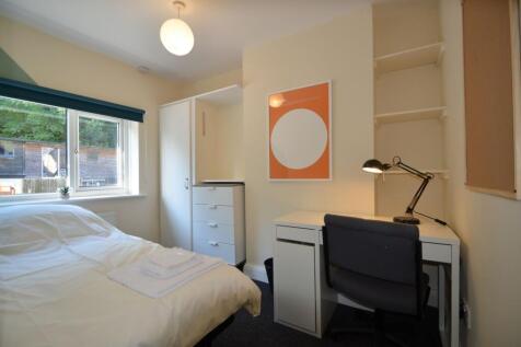 This inviting double bedroom features a cozy la...