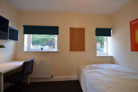 Spacious double bedroom featuring large windows...