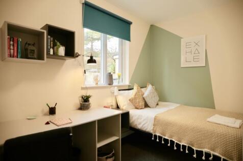 This cozy double bedroom features a comfortable...