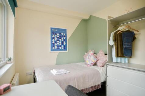 This cozy double bedroom features a comfortable...