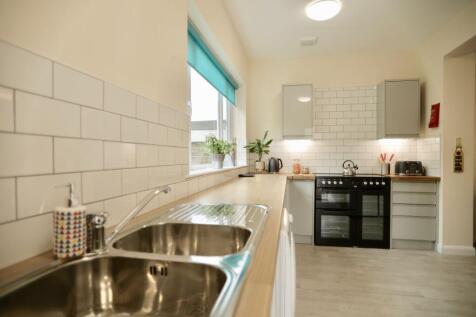 This bright and inviting kitchen features moder...