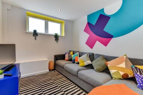A vibrant living room featuring a cozy gray sof...