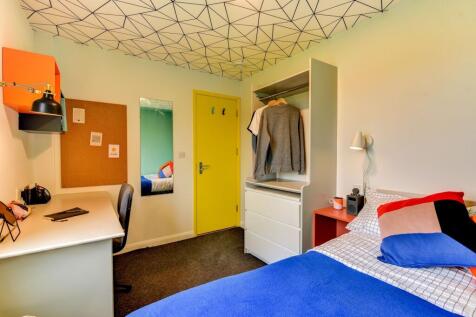 This inviting double bedroom features a cozy la...
