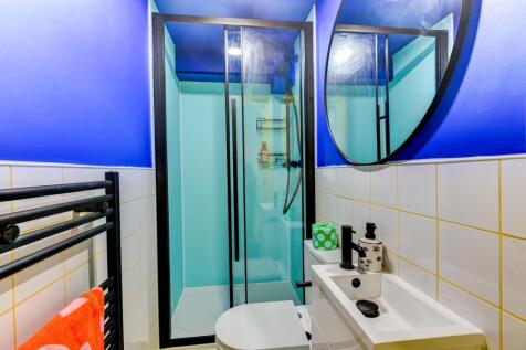 Modern bathroom featuring a sleek shower enclos...