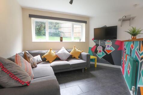 This cozy living room features a stylish grey s...