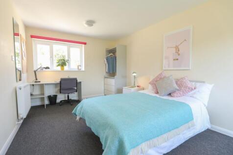 This inviting double bedroom features a cozy at...