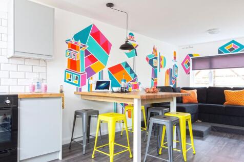 Bright and modern kitchen area featuring vibran...
