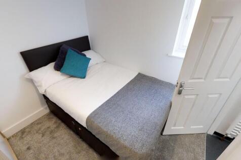 Cozy double bedroom featuring a comfortable bed...