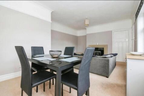 Spacious and inviting living room featuring a m...