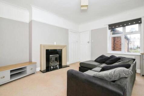 A cozy living room featuring a stylish fireplac...