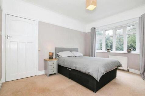 Cozy double bedroom featuring a comfortable bed...