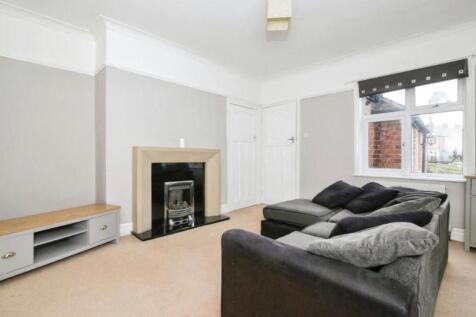 Spacious and inviting living room with a cozy f...