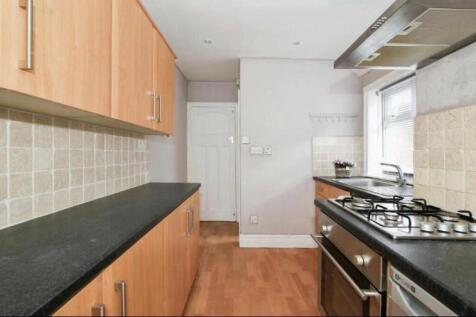 This modern kitchen features sleek cabinetry an...