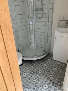 A clean and modern bathroom featuring a shower ...