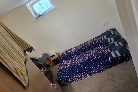 This cozy double bedroom features a comfortable...