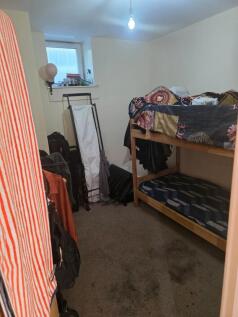Cozy double bedroom featuring ample storage spa...