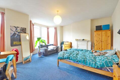 Spacious double bedroom featuring ample natural...
