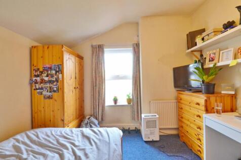 This charming double bedroom features a warm wo...