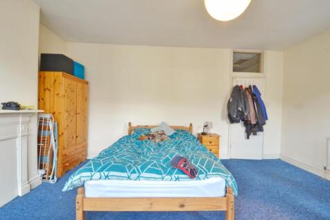 This inviting double bedroom features a cozy be...