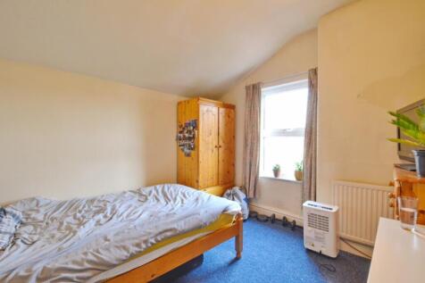 A cozy double bedroom featuring ample natural l...
